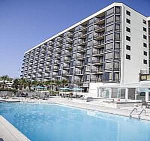 a large apartment building with a large swimming pool at Shell Island Resort - All Oceanfront Suites in Wrightsville Beach