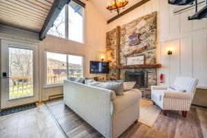 a living room with a couch and a stone fireplace at Walk to Liberty Mountain Lake-View Ski Retreat! in Fairfield