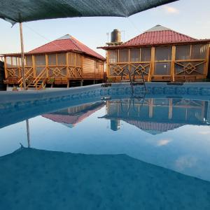 a resort with a pool and a house at Somos la experiencia LaCruzHouse in Paita