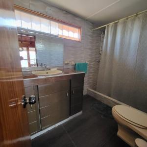 a bathroom with a sink and a toilet and a shower at Somos la experiencia LaCruzHouse in Paita