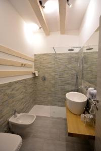 a bathroom with a sink and a toilet and a shower at Suite Manzoni in Boffalora sopra Ticino