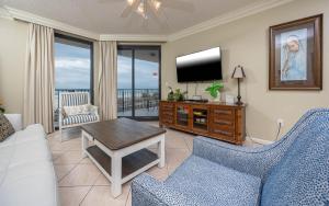 a living room with a couch and a tv at Phoenix X 211 condo in Orange Beach