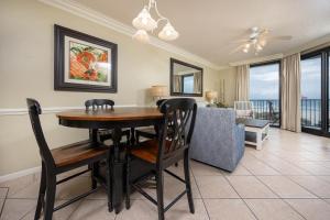 a dining room with a table and chairs and a couch at Phoenix X 211 condo in Orange Beach
