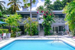 a hotel with a swimming pool in front of a building at The Palms Resort in Saint James