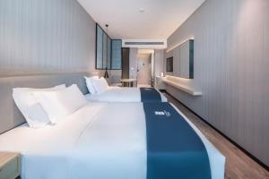 Letto o letti in una camera di Echarm Hotel Nanning East Railway Station
