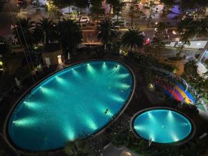an overhead view of two swimming pools at night at Vinhomes Landmark Luxury Apartment by Navie in Ho Chi Minh City