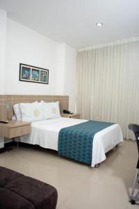 Ένα ή περισσότερα κρεβάτια σε δωμάτιο στο Hotel Cinco Monteria
