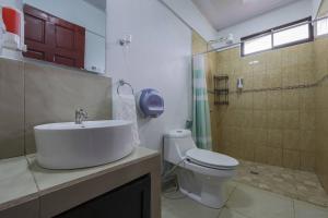 a bathroom with a sink and a toilet and a shower at La Casa Amarilla in Fortuna +37 photos