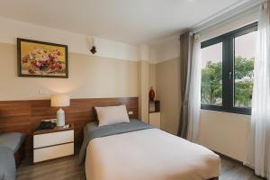 Postel nebo postele na pokoji v ubytování An Nguyen Boutique Hotel