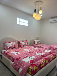 a bedroom with a bed with hello kitty pillows at Pani House Hatyai 5 in Hat Yai