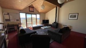 a living room with two couches and a tv at Rangers 2 'Morgan' in Mount Hotham