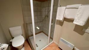 a bathroom with a shower with a toilet and towels at Rangers 2 'Morgan' in Mount Hotham +21 photos