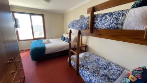 a bedroom with two bunk beds and a window at Rangers 2 'Morgan' in Mount Hotham