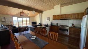 a kitchen and living room with a table and a dining room at Rangers 2 'Morgan' in Mount Hotham