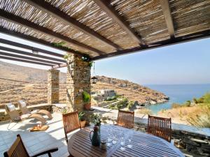 a patio with a table with a view of the ocean at Stunning seafront apartment in Kea in Korissia