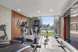 a gym with treadmills and elliptical machines at Newly built with WiFi & Healthclub, pool & gym access in Inverloch