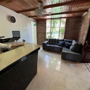a kitchen and living room with a couch and a counter at Hotel Rodadero Relax in Gaira +11 photos