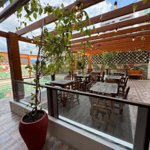 a patio with tables and chairs and a potted plant at Hotel Rodadero Relax in Gaira