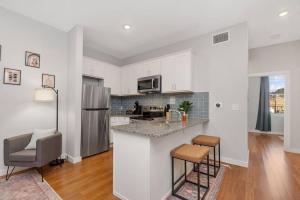 a kitchen with white cabinets and a counter top at Prime OTR off Vine St, Lux Full Bed, Fast WiFi, Fully Equipped, 50in TV, Sleeps 4ppl in Cincinnati