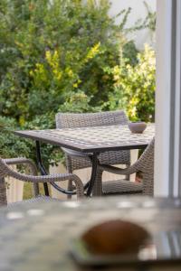 a table and chairs on a porch with a bowl on it at Hotel La Villa Del Mare in Cagliari