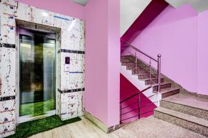 a staircase in a pink building with a purple wall at Super Collection O Harsh Regency in Rānchī