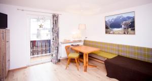 a living room with a table and a couch at Haus Tyrol in See