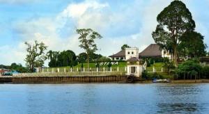 a house sitting on the side of a river at Place2Stay Business Hotel @ Metrocity in Kuching