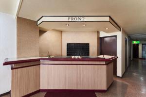 a front desk of a hotel with a front sign at Hotel Paco Obihiro Chuo in Obihiro