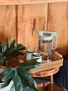 a coffee maker on a table with a plant at Cô Ba Măng Đen Homestay in Kon Von Kla
