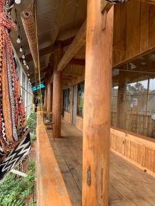 a large building with wooden posts and a porch at Cô Ba Măng Đen Homestay in Kon Von Kla