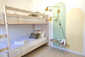 a room with two bunk beds with a lamp and a table at Retreat yourself in Cozy vibes & so much to Discover in Alcobaça +21 photos