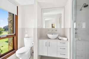 a white bathroom with a toilet and a sink at Exeter House Estate Vineyard Residence in Exeter +19 photos