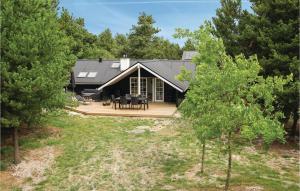 an aerial view of a house with a deck at Four-Bedroom Holiday Home In Blavand in Blåvand +20 photos