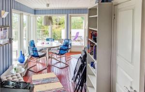 a dining room with blue chairs and a table at Lovely Home In Enebakk With Wifi in Omberg