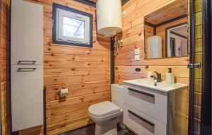 a tiny bathroom with a toilet and a sink at Beautiful Home In Pogorzelica in Pogorzelica