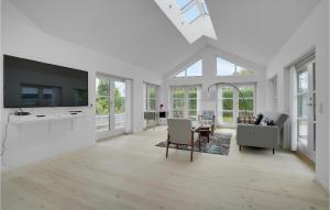 a living room with white walls and a large tv at Lovely Home In Rødvig Stevns With Wifi in Rødvig