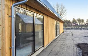 a building with sliding glass doors on the side of it at 4 Bedroom Stunning Home In Ystad in Ystad