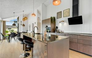 a kitchen with a bar and a living room at 4 Bedroom Beautiful Home In Hemmet in Hemmet