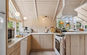 a kitchen with wood paneled walls and a ceiling at Three-Bedroom Holiday Home In Sjallands Odde in Yderby