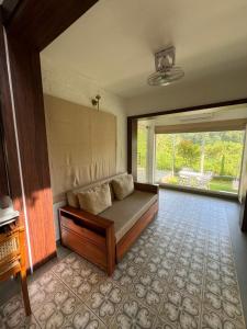 a room with a bed and a large window at River Wild holiday home in Athirappilly +15 photos