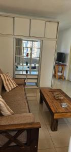 a living room with a couch and a wooden table at Palermo Apart 3 in Buenos Aires +17 photos