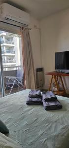 two towels sitting on top of a bed in a room at Palermo Apart 3 in Buenos Aires