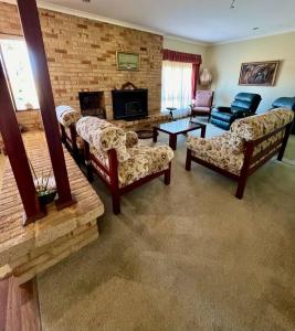 a living room with couches and a brick wall at Myra Downs in Harvey