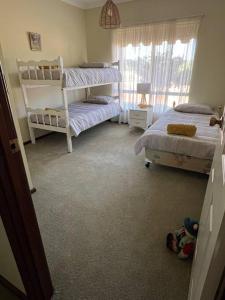 a bedroom with two bunk beds and a window at Myra Downs in Harvey