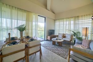 a living room with a couch and a table at Rio Royale in Candolim