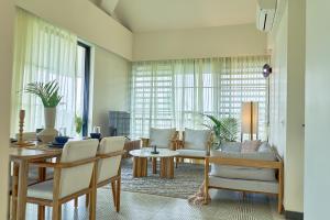 a living room with a table and chairs at Rio Royale in Candolim