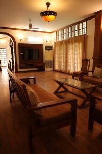 a living room with a couch and a table at Puzhayoram holiday home, Aluva in Alwaye
