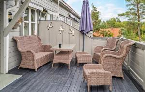 un grupo de sillas y una mesa en una terraza en Awesome Home In Lillesand With Wifi, en Lillesand 9 fotos más