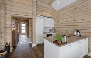 a kitchen with wooden walls and a counter top at Sjusjøen Setergrend 4724 B in Sjusjøen