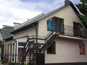 a house with a staircase on the side of it at Nakvisa in Zarasai